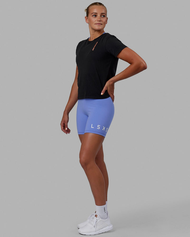 Woman wearing Good Times Global Tee - Black