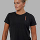 Woman wearing Good Times Global Tee - Black