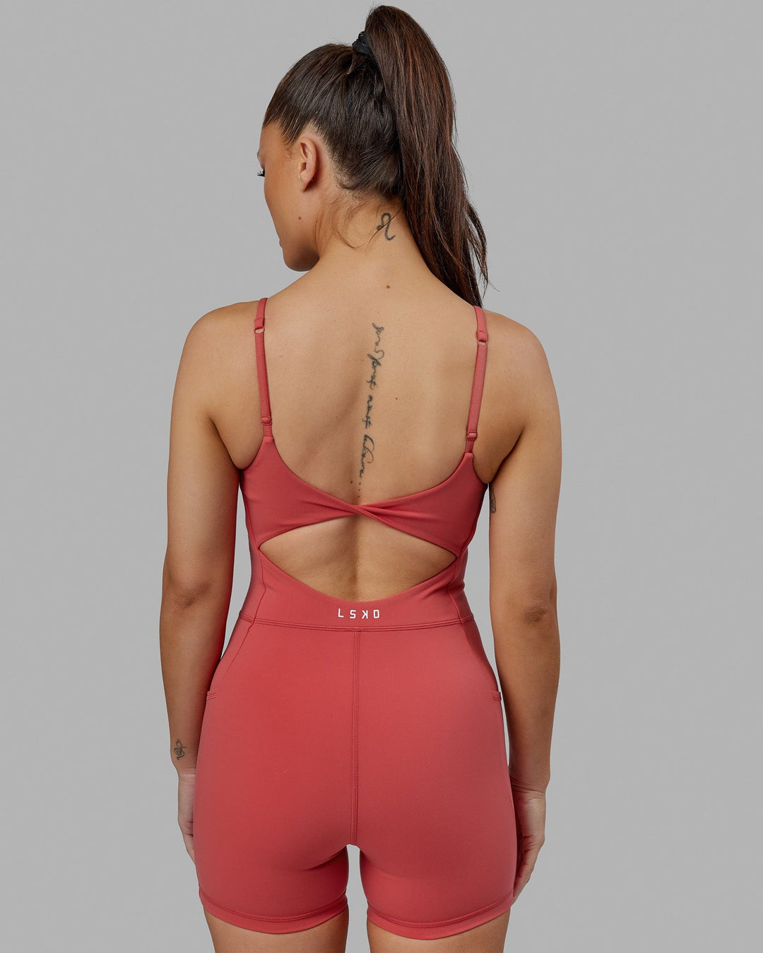 Woman wearing Helix Active Bodysuit - Mineral Red