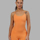 Woman wearing Helix Active Bodysuit - Tangerine
