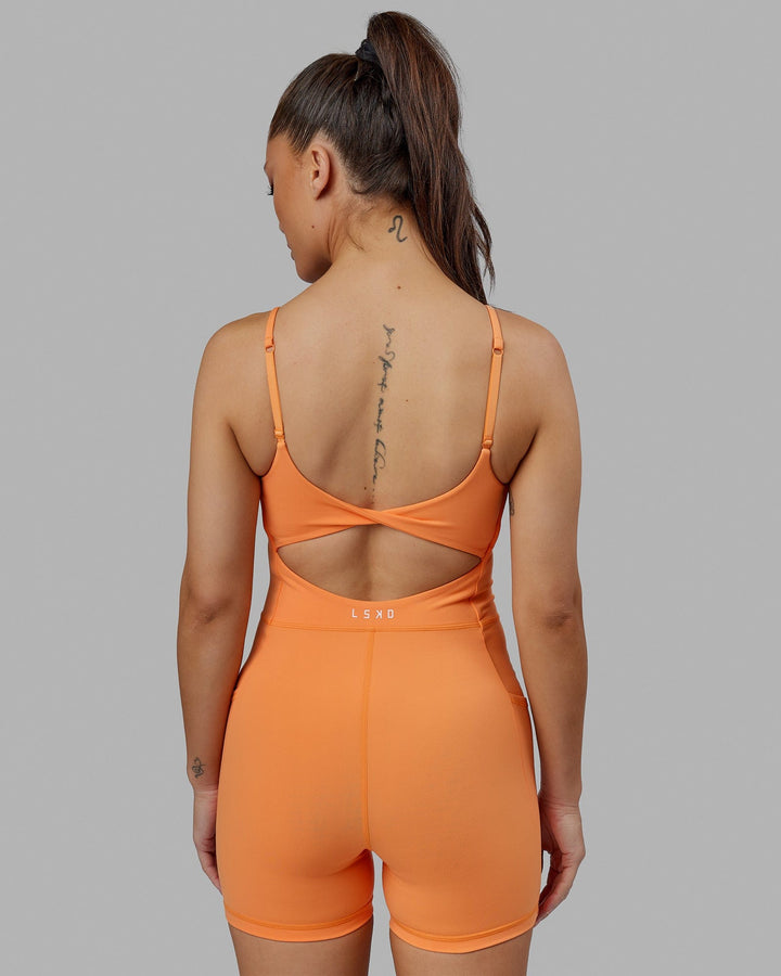 Woman wearing Helix Active Bodysuit - Tangerine