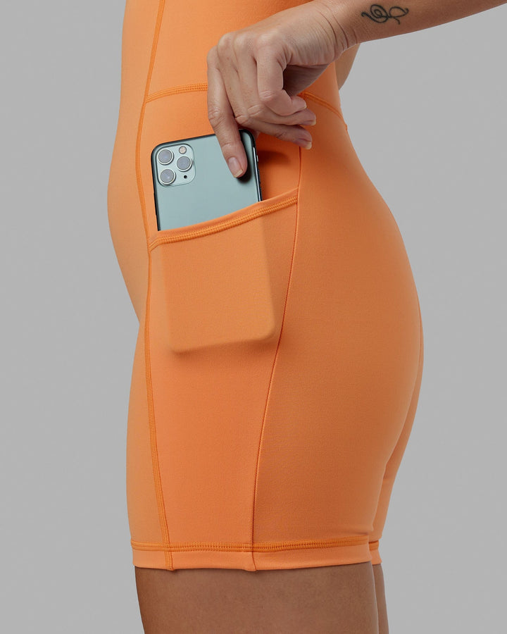 Woman wearing Helix Active Bodysuit - Tangerine