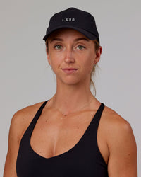 Woman wearing Hybrid Performance Cap - Black