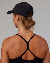 Woman wearing Hybrid Performance Cap - Black