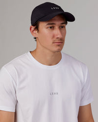 Man wearing Hybrid Performance Cap - Black
