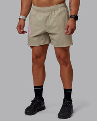 Man wearing Lift 6" Performance Shorts - Sand-So Cal 24