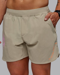 Man wearing Lift 6" Performance Shorts - Sand-So Cal 24