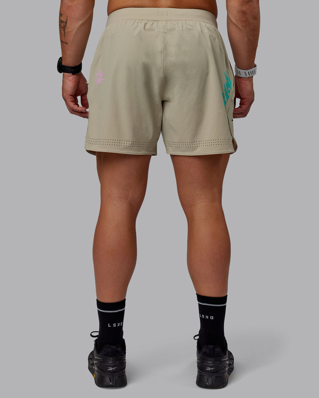 Man wearing Lift 6" Performance Shorts - Sand-So Cal 24