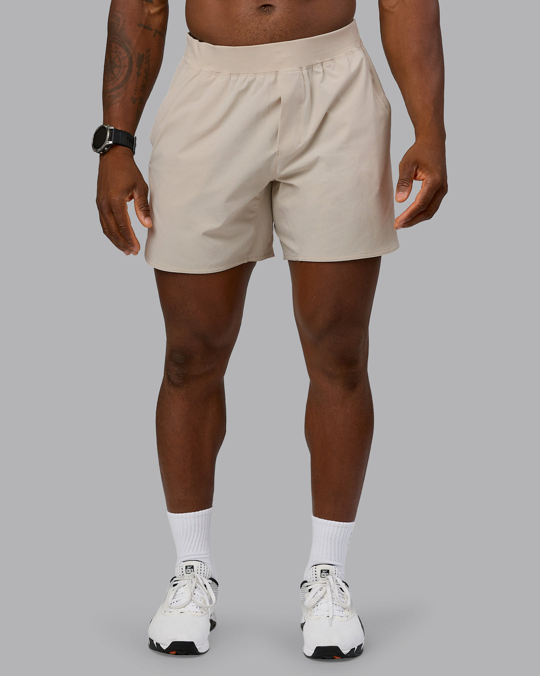 Man wearing Lift 6&quot; Performance Short - Shale-Beige | Model:Sam | Size:L
