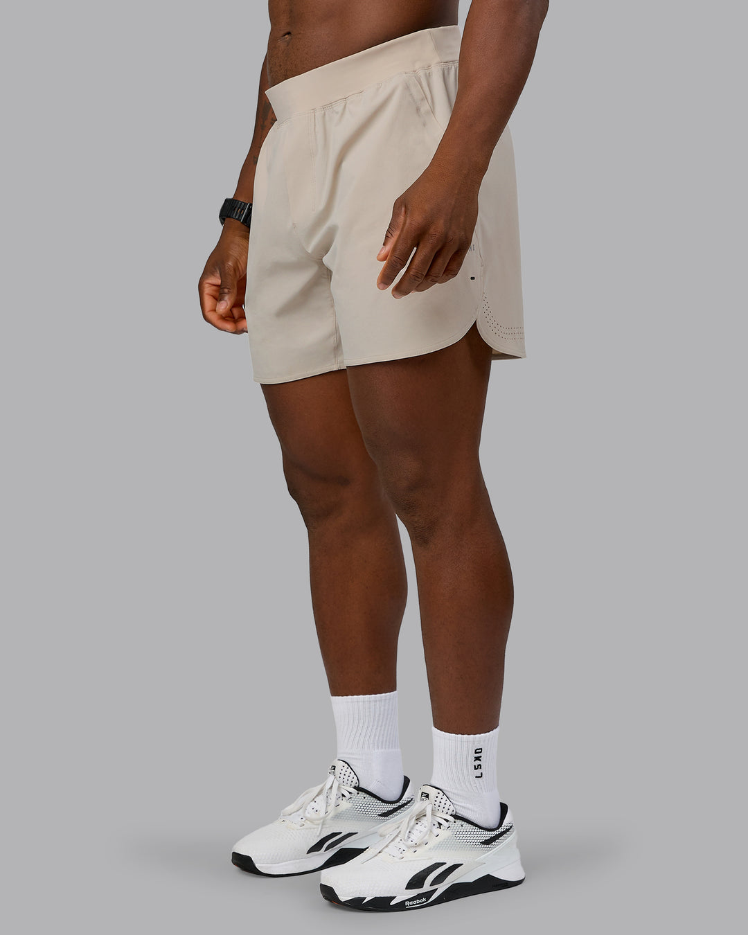 Man wearing Lift 6&quot; Performance Short - Shale-Beige | Model:Sam | Size:L