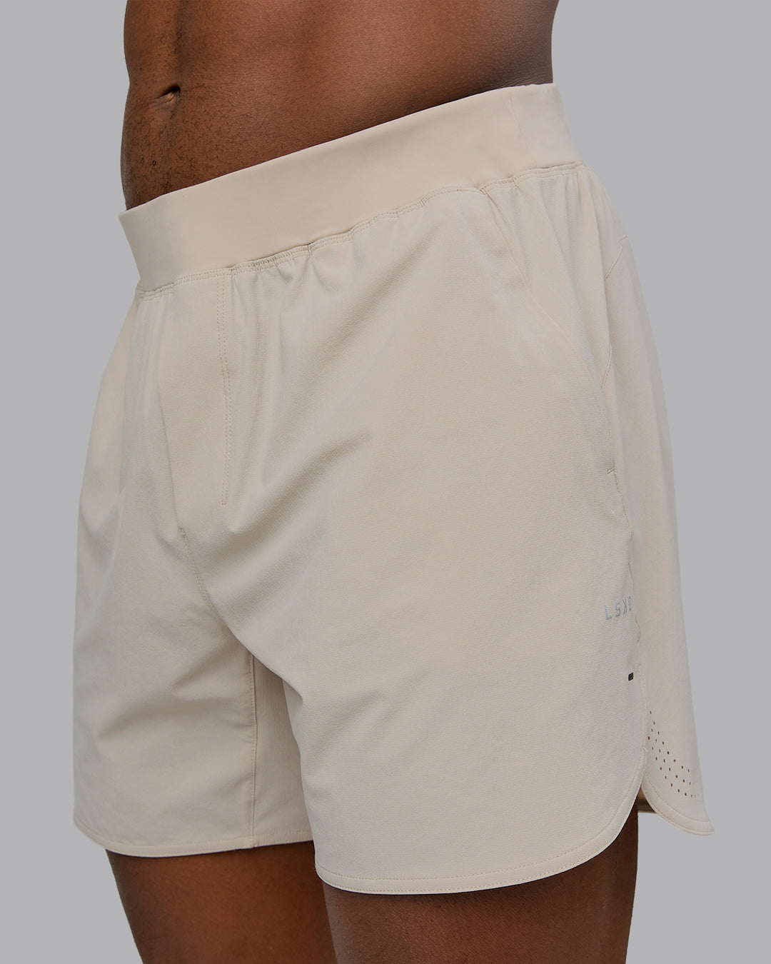 Man wearing Lift 6&quot; Performance Short - Shale-Beige | Model:Sam | Size:L