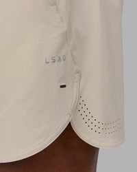 Man wearing Lift 6" Performance Short - Shale-Beige | Model:Sam | Size:L