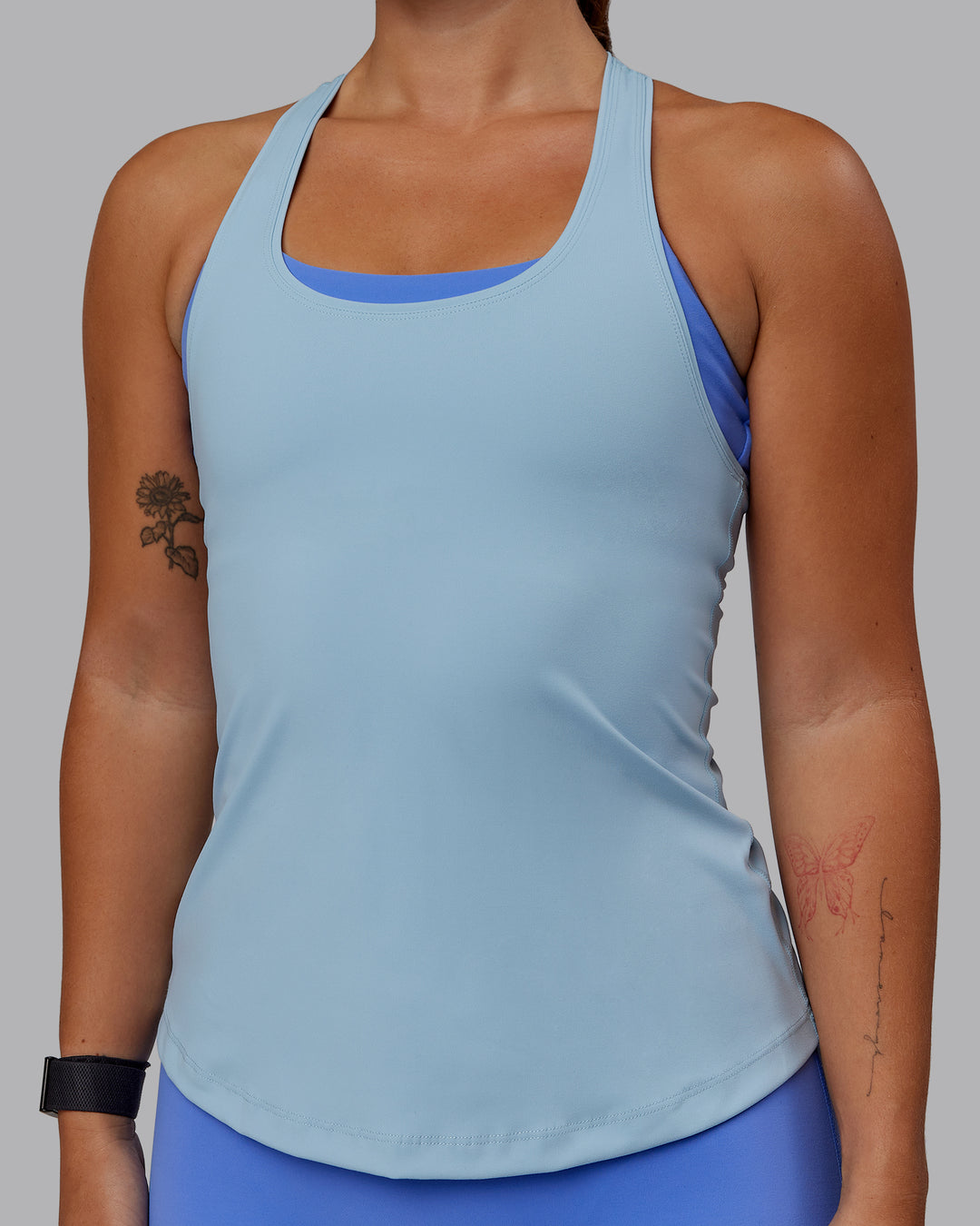 Woman wearing Lift Performance Tank - Glacial Blue