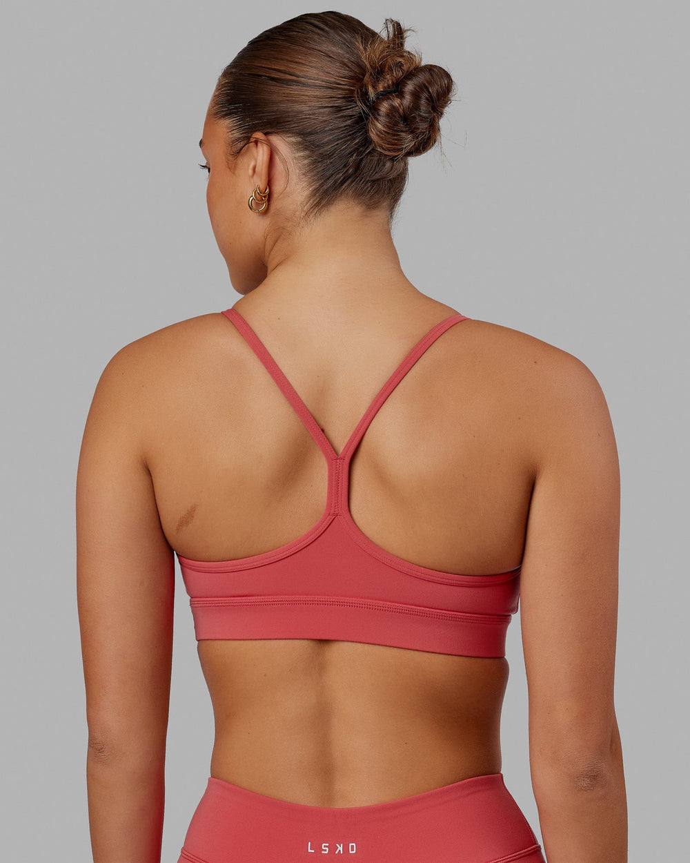 Woman wearing Lift Sports Bra - Mineral Red