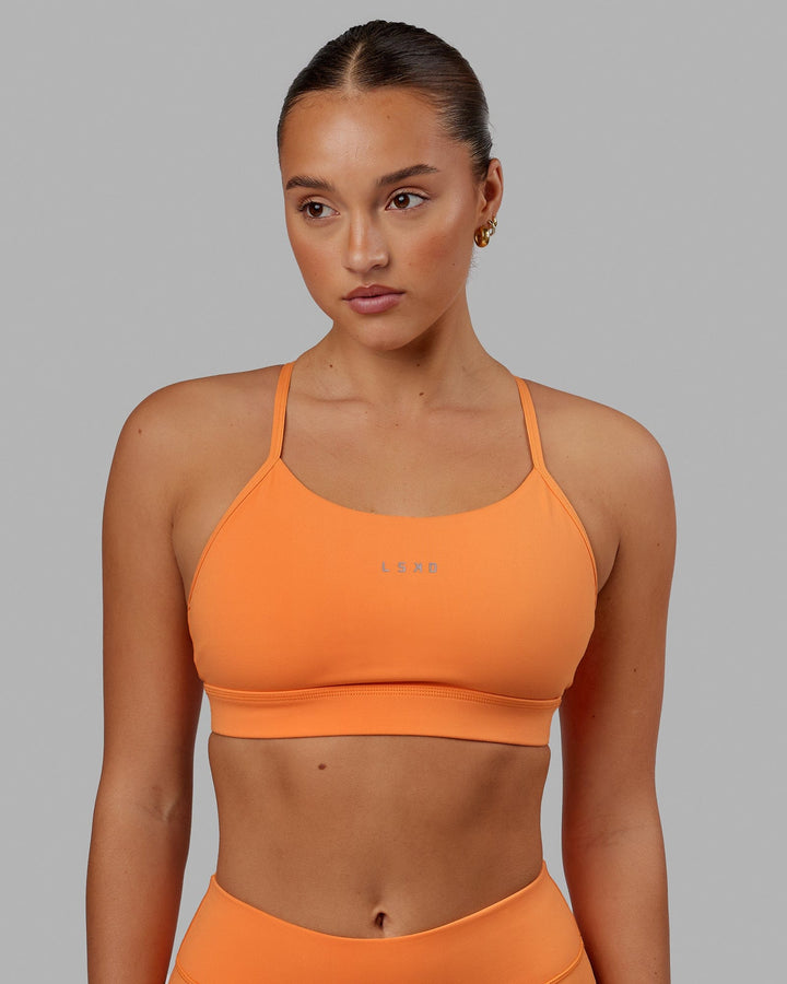 Woman wearing Lift Sports Bra - Tangerine