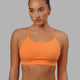 Woman wearing Lift Sports Bra - Tangerine