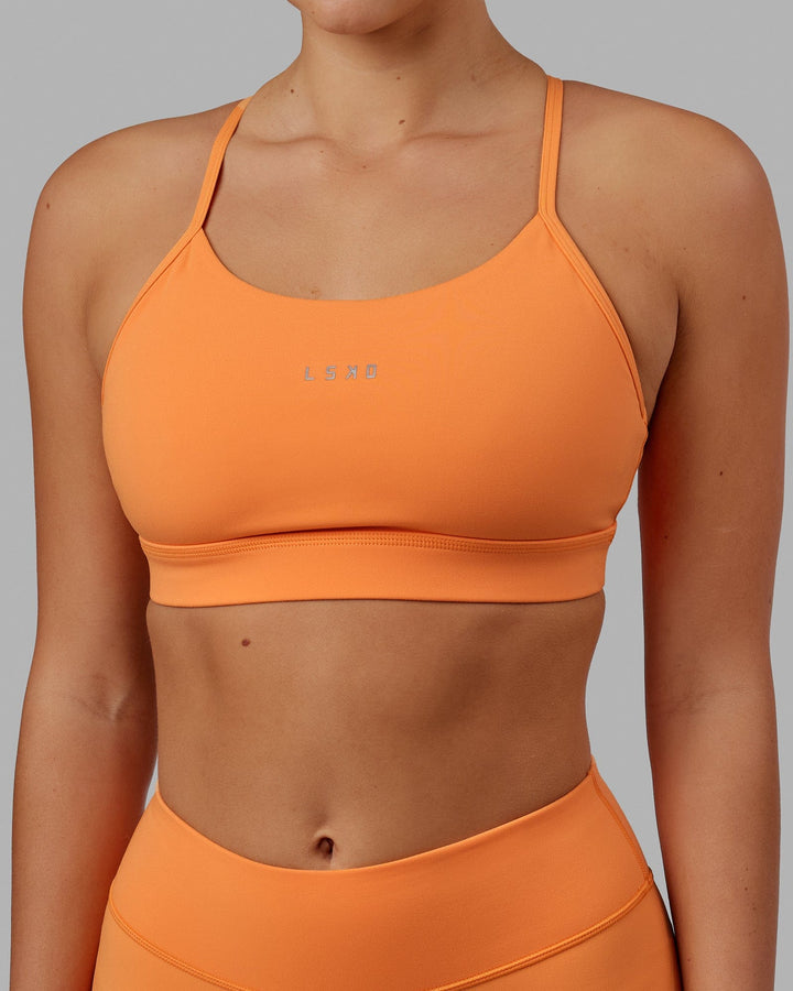 Woman wearing Lift Sports Bra - Tangerine