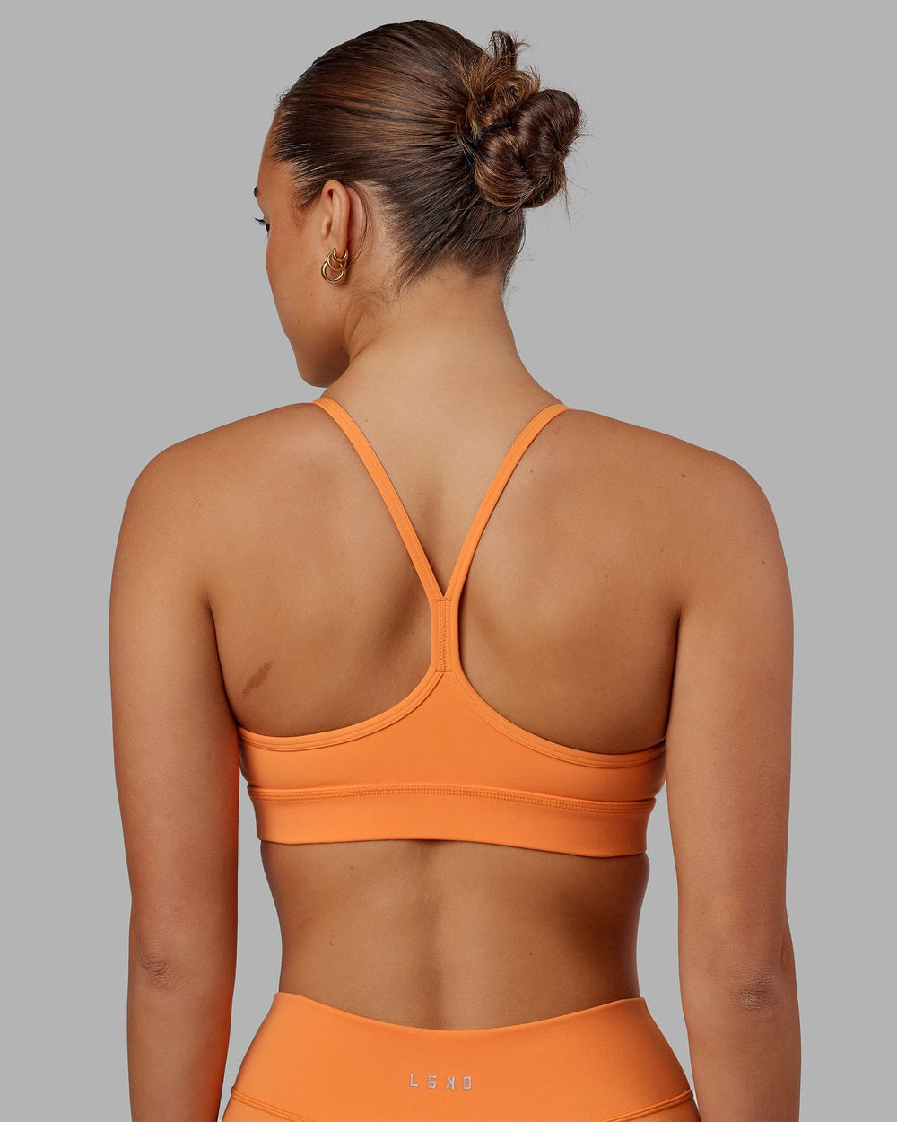 Woman wearing Lift Sports Bra - Tangerine