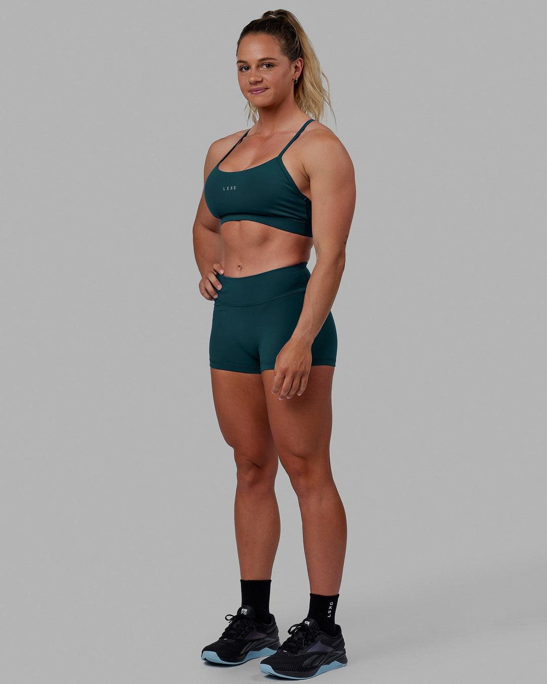 Woman wearing Lift Sports Bra - Tidal Teal