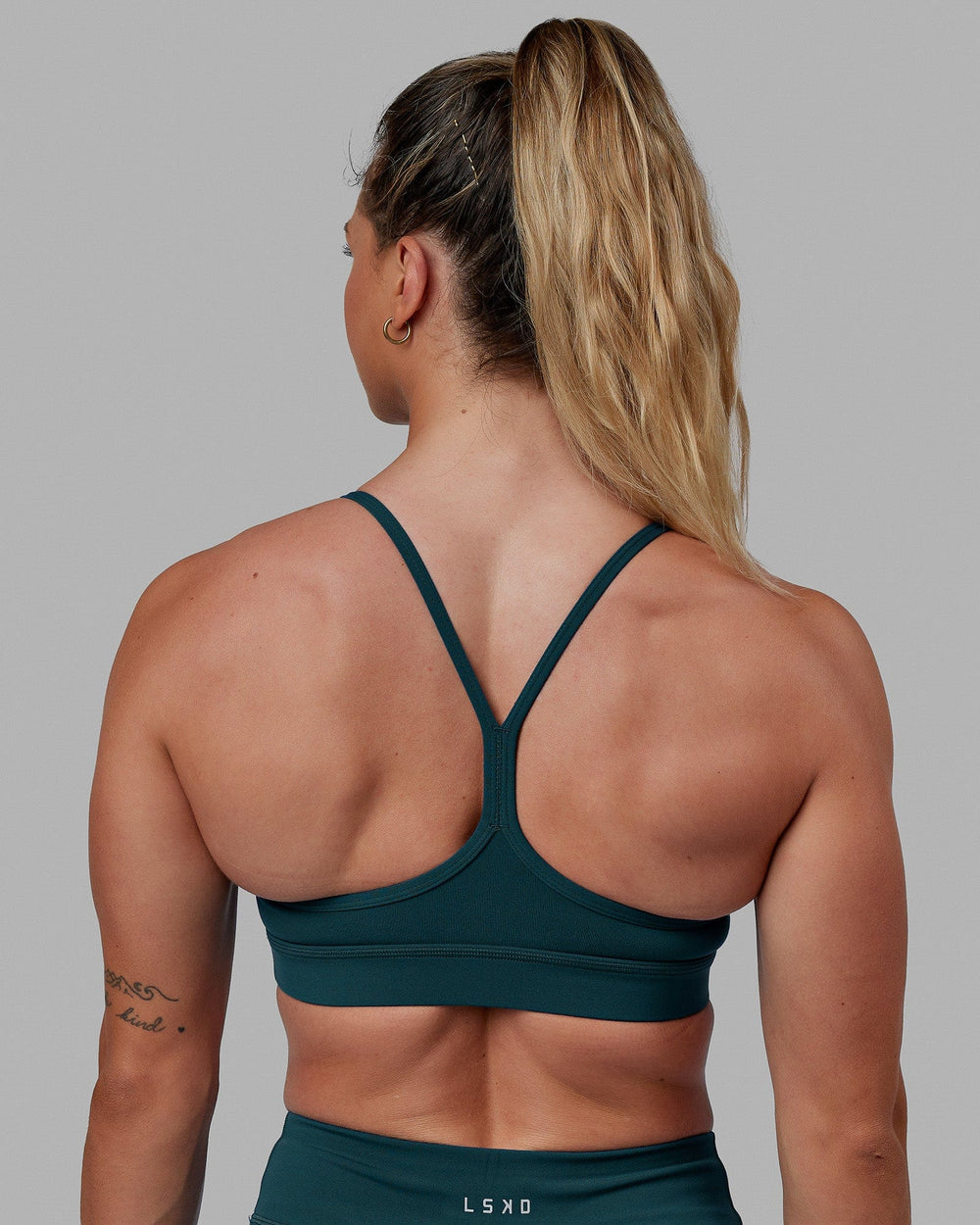 Woman wearing Lift Sports Bra - Tidal Teal