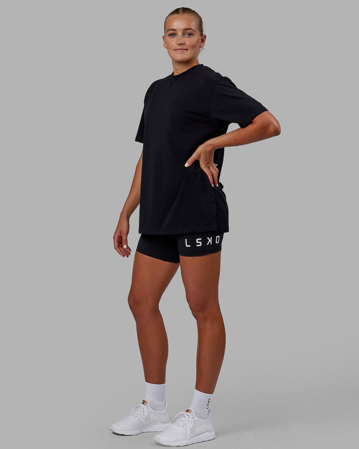 Woman wearing Unisex Lifting Club FLXCotton Tee Oversize - Black-White-Yellow