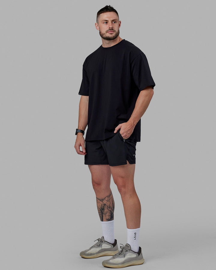 Man wearing Unisex Lifting Club FLXCotton Tee Oversize - Black-White-Yellow