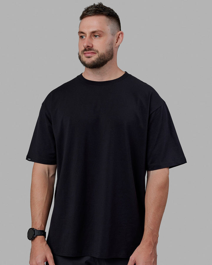 Man wearing Unisex Lifting Club FLXCotton Tee Oversize - Black-White-Yellow