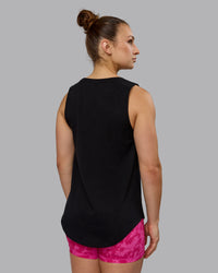 Woman wearing Luna FLXCotton Longline Tank - Black-Ultra Pink
