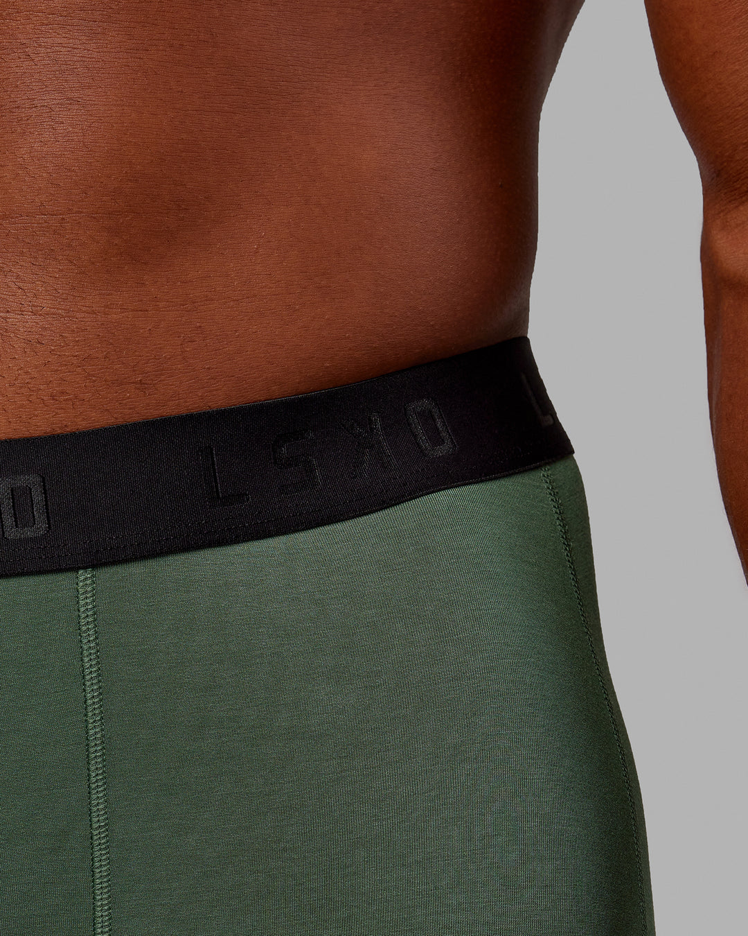 Man wearing MVP Trunks 3 Pack - Black/Cilantro/Midnight Blue
