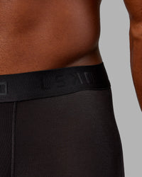Man wearing MVP Trunks 3 Pack - Black/Cilantro/Midnight Blue | Thumbnail Index: 11
