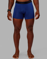 Man wearing MVP Trunks 3 Pack - Black/Cilantro/Midnight Blue | Thumbnail Index: 1