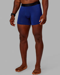 Man wearing MVP Trunks 3 Pack - Black/Cilantro/Midnight Blue | Thumbnail Index: 6