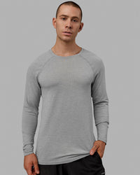 Man wearing AeroFLX+ Seamless Long Sleeve Tee - Light Grey Marl
