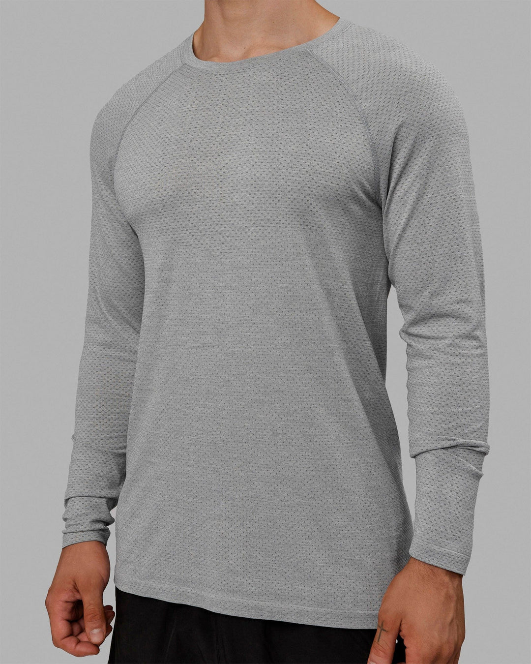 Man wearing AeroFLX+ Seamless Long Sleeve Tee - Light Grey Marl