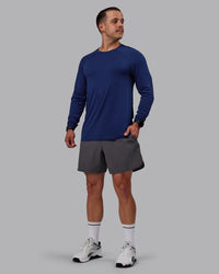 Man wearing AeroFLX+ Seamless Long Sleeve Tee - Midnight Blue/Midnight Blue Marl