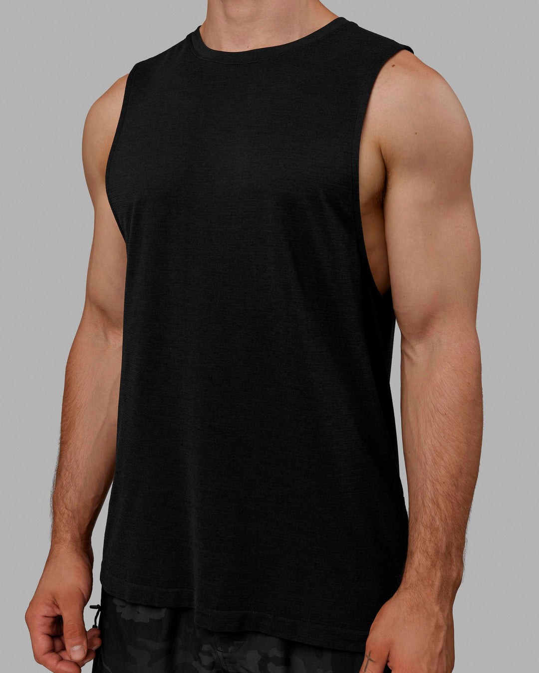 Man wearing AeroFLX+ Seamless Muscle Tank - Black Marl