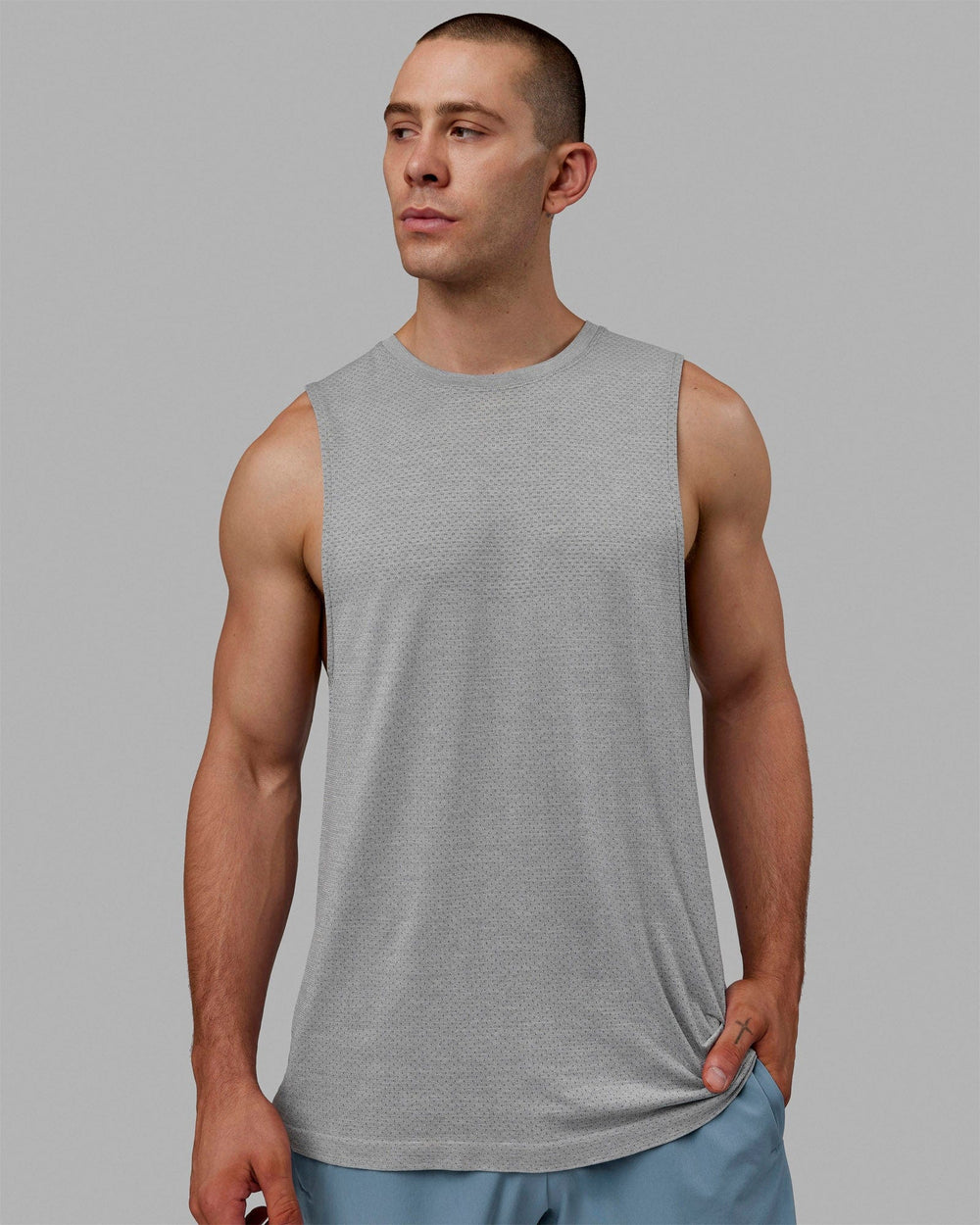 Man wearing AeroFLX+ Seamless Muscle Tank - Lt Grey Marl