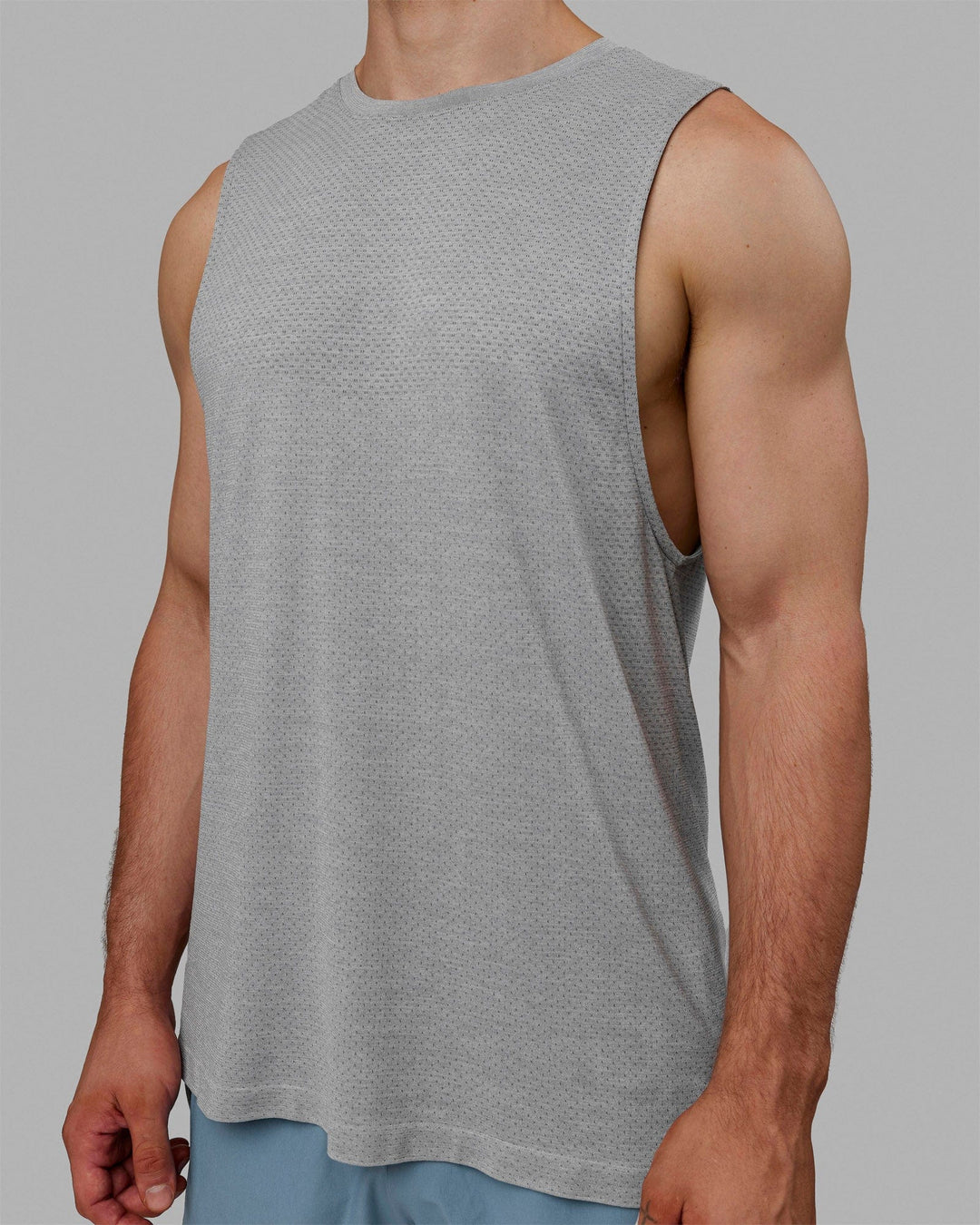 Man wearing AeroFLX+ Seamless Muscle Tank - Lt Grey Marl