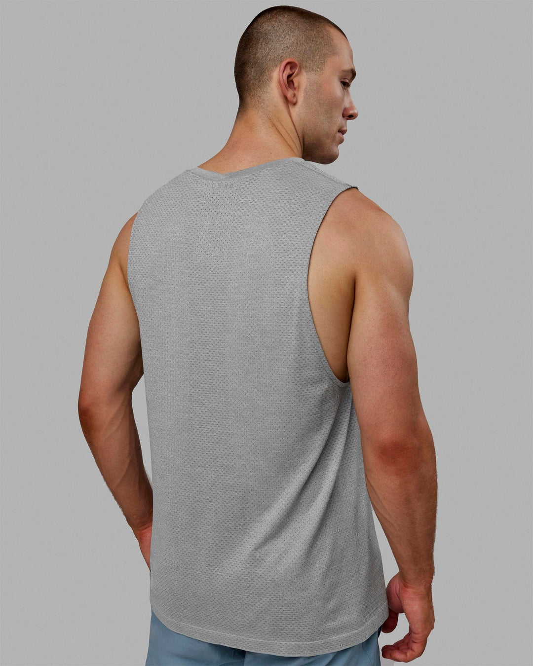 Man wearing AeroFLX+ Seamless Muscle Tank - Lt Grey Marl