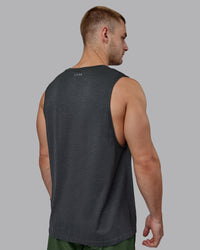 Man wearing AeroFLX+ Seamless Muscle Tank - Pirate Black Marl
