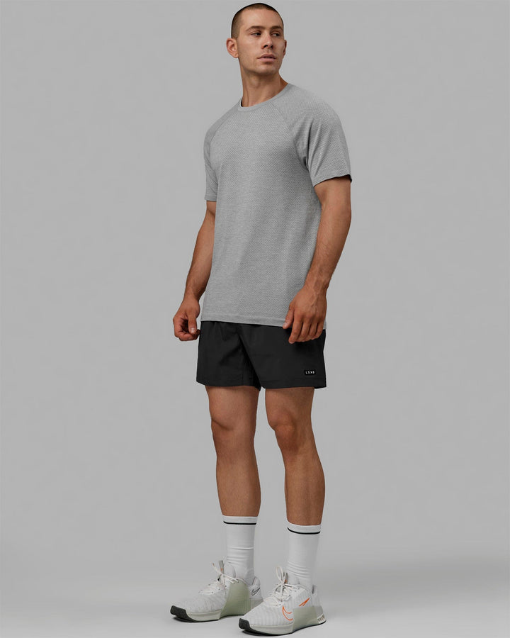 Man wearing AeroFLX+ Seamless Tee - Light Grey Marl
