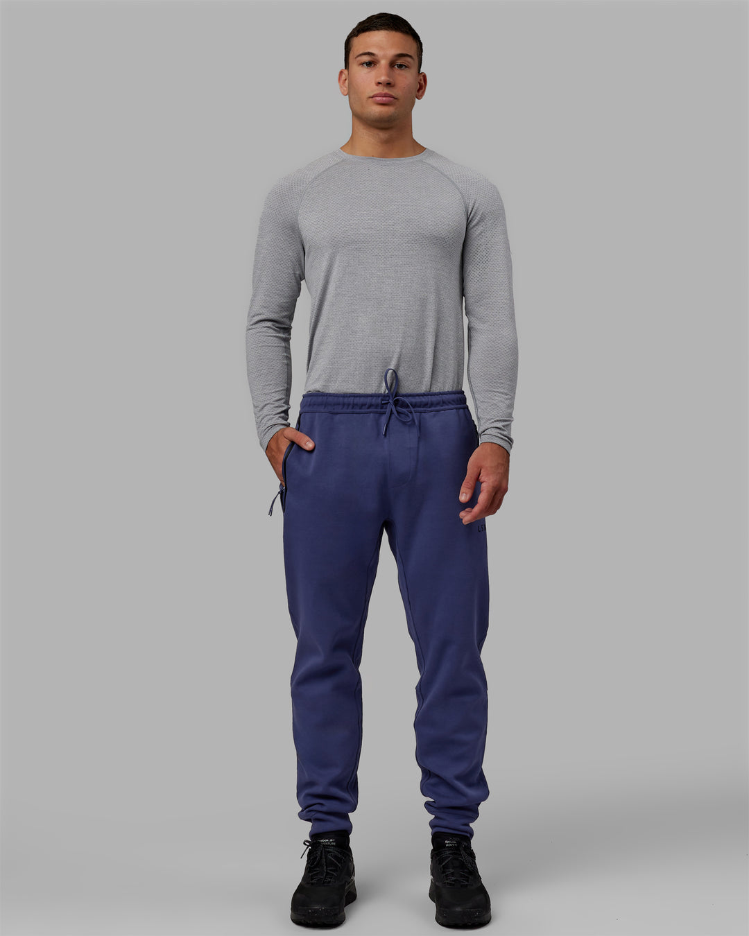 Man wearing Athlete ForgedFleece Zip Track Pants - Future Dusk