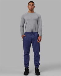 Man wearing Athlete ForgedFleece Zip Track Pants - Future Dusk