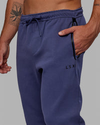 Man wearing Athlete ForgedFleece Zip Track Pants - Future Dusk