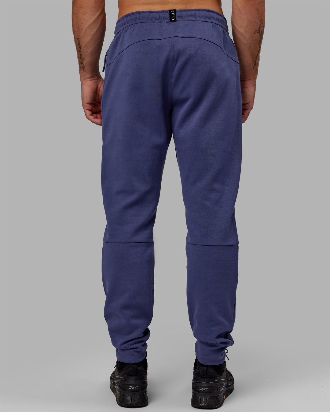 Man wearing Athlete ForgedFleece Zip Track Pants - Future Dusk