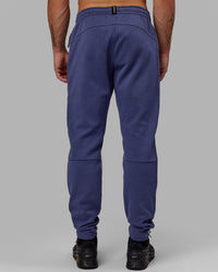 Man wearing Athlete ForgedFleece Zip Track Pants - Future Dusk