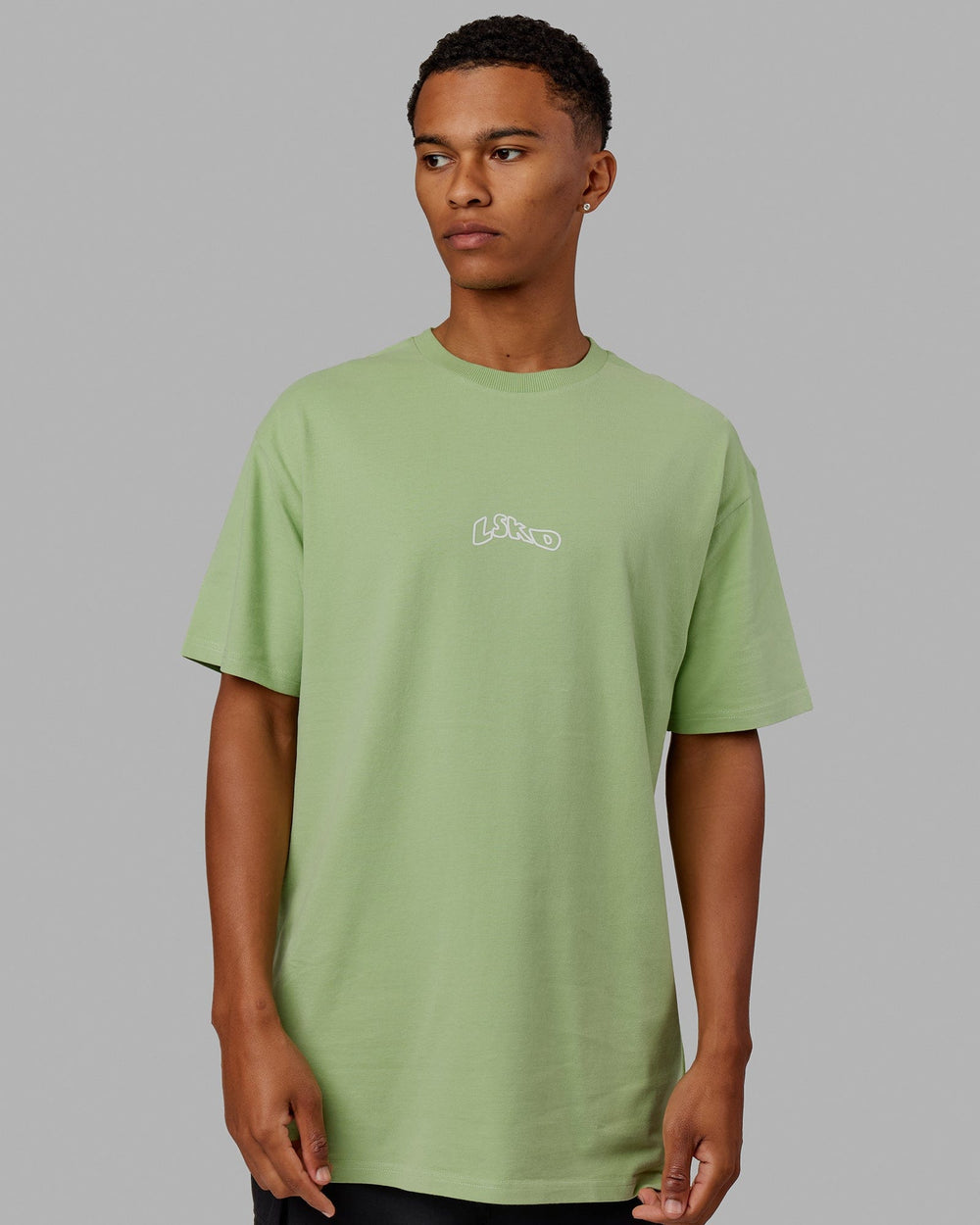 Man wearing Mad Happy Heavyweight Longline Tee Oversize - Green Fig