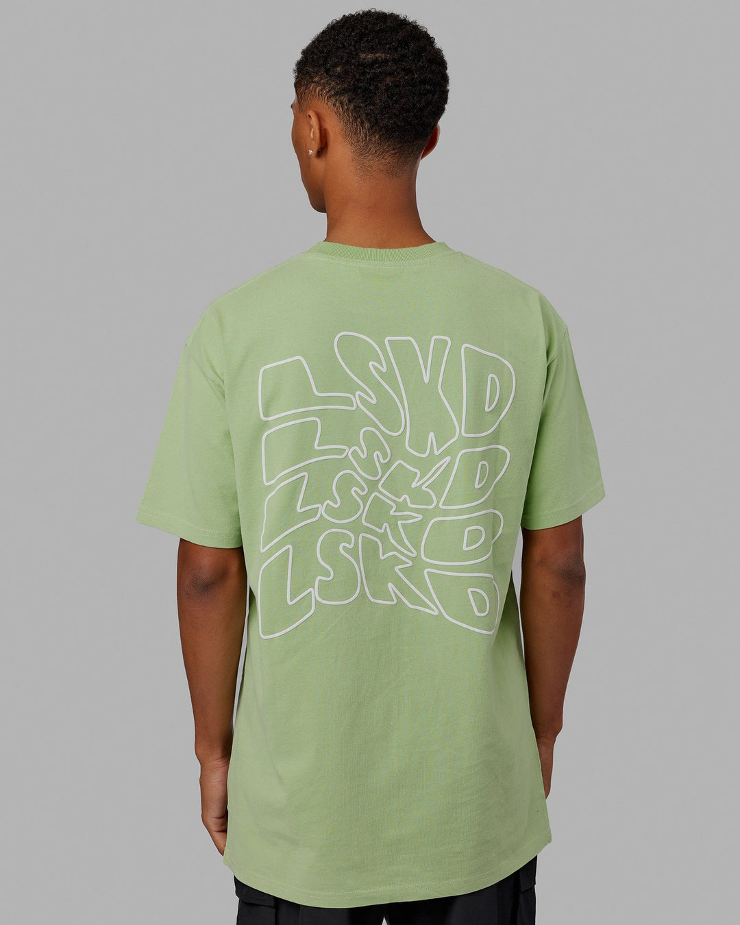 Man wearing Mad Happy Heavyweight Longline Tee Oversize - Green Fig