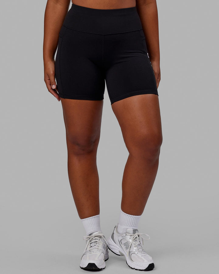 Woman wearing Rep Mid Short Tight - Pride-Black