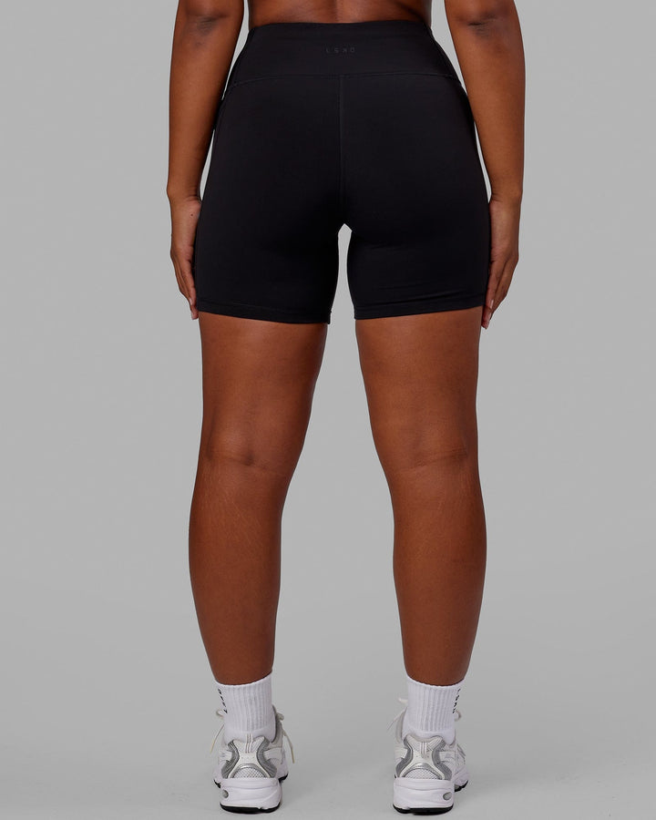 Woman wearing Rep Mid Short Tight - Pride-Black